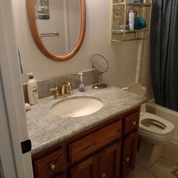 Cornell Construction - Old bath granite countertop, faucet. Before painting cabinet and mirror. - General Contractors Near Me - Placerville, California