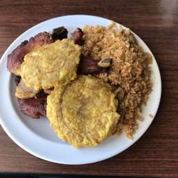Tostones, rice and two chops of meat. Tostones, rice and two chops of meat.
