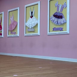 Pretty framed tutus as points to stand under for the learning students. Smart!