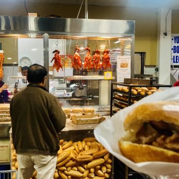 Ca Mau Supermarket - a man holding a sandwich - International Grocery Near Me - Cypress, Texas Ca Mau Supermarket - a man holding a sandwich - International Grocery Near Me - Cypress, Texas