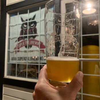 Super Owl Brewing - a hand holding a glass of beer - Breweries Near Me - Davis, California