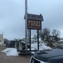a truck parked in front of a sign