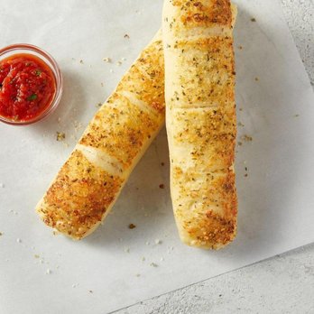 Sbarro - a pair of breadsticks on a piece of paper with a small bowl of ketchup - Pizza Near Me - Merrillville, Indiana Sbarro - a pair of breadsticks on a piece of paper with a small bowl of ketchup - Pizza Near Me - Merrillville, Indiana