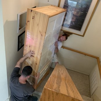 QShark Moving Services - Moving heavy cabinet while trying to negotiate narrow stairway - Movers Near Me - Rancho Cucamonga, California QShark Moving Services - Moving heavy cabinet while trying to negotiate narrow stairway - Movers Near Me - Rancho Cucamonga, California