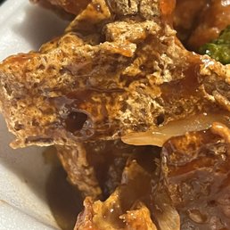 a close up of a plate of meat and broccoli