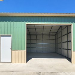 Best National Carports - Front lean to  with a walk-in door a long roll-up door