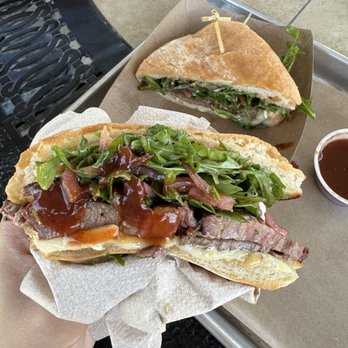 Corner BBQ Shack - Close up of the delicious Texas Wagyu steak sandwich with some bbq sauce - Barbeque Near Me - McKinney, Texas