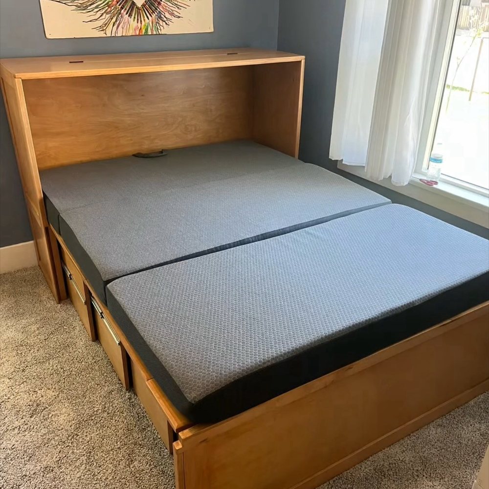 Fully extended bed with foldable mattress.