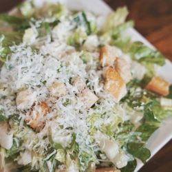 Fable at Toast Brea - Caesar Salad (side dish). Finely shredded Parmesan with crisp romaine lettuce, evenly coated in Caesar dressing, and croutons.