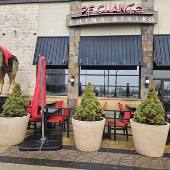 P.F. Chang's - P.F. Chang's China Bistro storefront with outdoor seating, potted plants, and a horse statue visible on the left. - Chinese Near Me - Hackensack, New Jersey