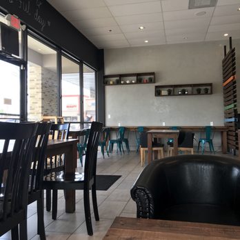 Cocohodo - View from sofa of front entrance. Far wall has counter seating with electrical plugs for devices. - Coffee & Tea Near Me - Katy, Texas Cocohodo - View from sofa of front entrance. Far wall has counter seating with electrical plugs for devices. - Coffee & Tea Near Me - Katy, Texas