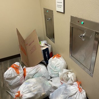 Amalfi Apartment Homes - Trash in the trash room. People don't even bother to drop their own trash down the trash shoot! - Apartments Near Me - Tustin, California