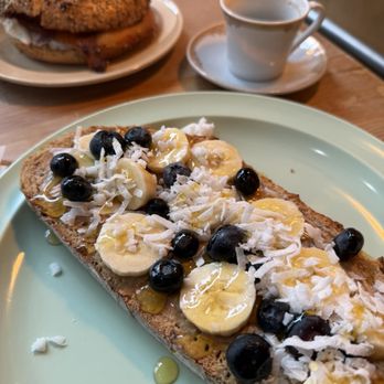 Penny’s Coffee Shop - Peanut butter toast with bananas, blueberries, honey and coconut - Coffee & Tea Near Me - Buffalo, New York Penny’s Coffee Shop - Peanut butter toast with bananas, blueberries, honey and coconut - Coffee & Tea Near Me - Buffalo, New York