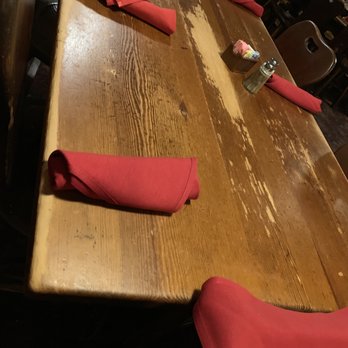 McBrides Land & Cattle - A wooden table with utensils and red napkins to boot. - Steakhouses Near Me - Wichita Falls, Texas