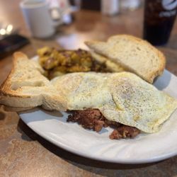 Raspberries Cafe - Two eggs over easy with hash, home fries and Italian toast