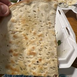 Docked holes in the back of the naan, which was tough and dense. Docked holes in the back of the naan, which was tough and dense.