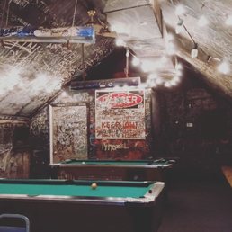 a pool table in the middle of the room a pool table in the middle of the room