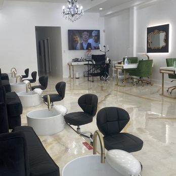 Salon De Manucure - Cute setup with three chandeliers (2 pictured) and matching manicure and pedicure work stations, LED lit mirrors and TV screens - Nail Salons Near Me - Los Angeles, California