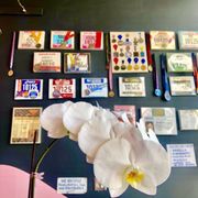 Photo of Crazy Fish - Beverly Hills, CA, United States. Interior wall with numerous awards, orchid photo bomb
