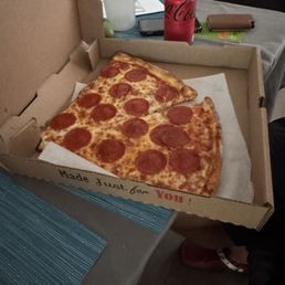 Two pepperoni pizza slices Two pepperoni pizza slices
