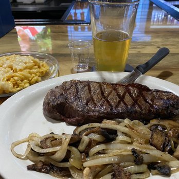Johnnie's on 2 - NY steak with sautéed onions and mushrooms. The Mac and cheese was dry and tasteless but the steak was very good. - American Near Me - St. Ignace, Michigan