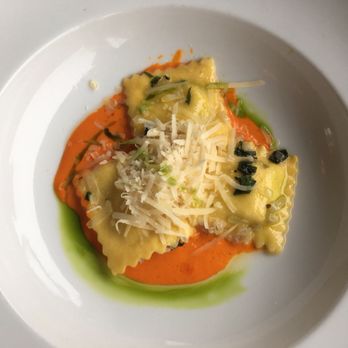 Thyme - Ravioli appetizer with exquisite red pepper sauce. Not really sure what the green sauce was but I licked it clean. - New American Near Me - Roslyn, New York