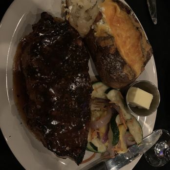 Daniella's Steakhouse - Ribeye, loaded baked potato and steamed veggies all good. Steak perfectly cooked to desired temperature. - Steakhouses Near Me - Syracuse, New York