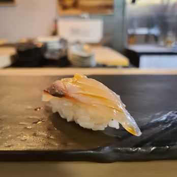 Shunoko - a piece of sushi on a black plate - Sushi Bars Near Me - Toronto, Ontario Shunoko - a piece of sushi on a black plate - Sushi Bars Near Me - Toronto, Ontario