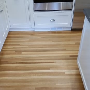 AMA Hardwood Floors - a kitchen with white cabinets and stainless steel appliances - Flooring Near Me - Beverly Hills, California AMA Hardwood Floors - a kitchen with white cabinets and stainless steel appliances - Flooring Near Me - Beverly Hills, California