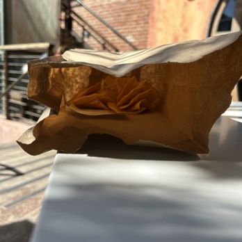 Mexicana - Came with side of chips - A paper bag containing potato chips is placed on a white table outdoors, with sunlight casting shadows. - Mexican Near Me - Berkeley, California