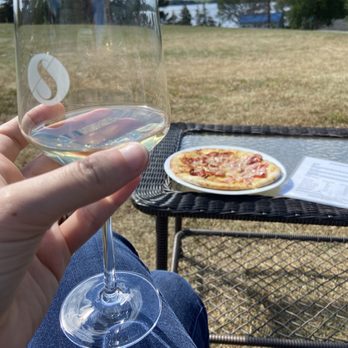 Scheuermann Vineyard & Winery - a person holding a glass of wine - Wineries Near Me - Westport, Ontario Scheuermann Vineyard & Winery - a person holding a glass of wine - Wineries Near Me - Westport, Ontario