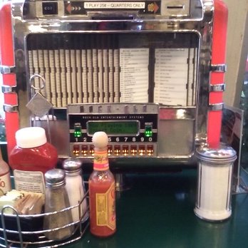 Mel's Drive-In - their cute mini jukebox on every table/booth with condiments. - Diners Near Me - Sherman Oaks, California