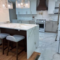 This custom kitchen was designed to be as functional as it is beautiful. From the dramatic waterfall island to the custom range hood and
