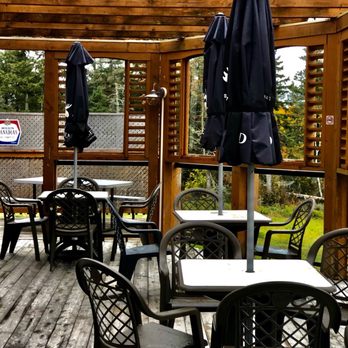 Up To Par - tables and umbrellas on a deck - Bars Near Me - Norton, New Brunswick