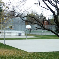 Jimmy Simpson Recreation Centre - Outdoor basketball court, tennis court and baseball diamond beyond