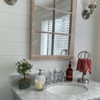 Stone Bridge - a bathroom sink with a mirror and soap dispenser - Landscaping Near Me Stone Bridge - a bathroom sink with a mirror and soap dispenser - Landscaping Near Me