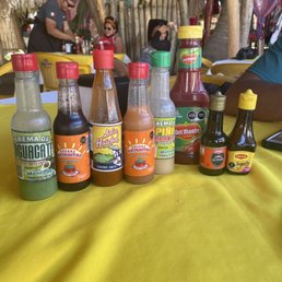 Different selection of hot sauces plus fresh pico de gallo and hot salsa