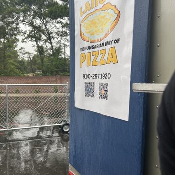 Langos - a sign on the side of a building - Food Trucks Near Me Langos - a sign on the side of a building - Food Trucks Near Me