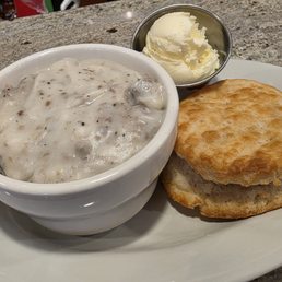 Side of sausage gravy and single biscuit