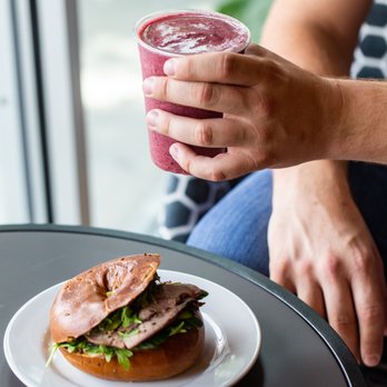 Coffee Fellows - a person holding a drink and a sandwich - Coffee & Tea Near Me - Bellaire, Texas