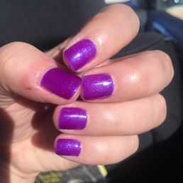 Purple & sparkling nails. Great color, not so great application.