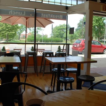 Kolache Republic - Black stools and chairs contrast light faux-wood flooring, and thin framework behind spanning natural lightening, great for summer mornings - Cafes Near Me - Columbus, Ohio