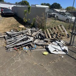 J & S Junk Removal Services - Before - pile of pallets, wood and other debris