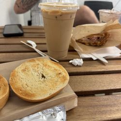 Ground Up Coffee - Iced latte and a plain bagel with cream cheese. Ham and cheese croissant in the back