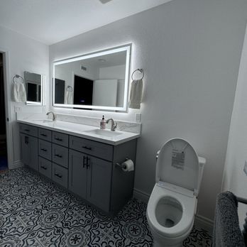 Legacy Remodeling and Construction - Finished area, new toilet, bidet, lighted mirror, vanity, flooring, exhaust vent. - General Contractors Near Me - Newport Beach, California Legacy Remodeling and Construction - Finished area, new toilet, bidet, lighted mirror, vanity, flooring, exhaust vent. - General Contractors Near Me - Newport Beach, California
