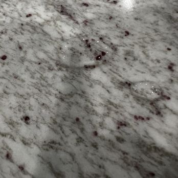 Meta Stone - Close up Of burgundy flecks after sealing. River White granite with deep burgundy flecks. 3-15-2024 - Countertop Installation Near Me - Farmingdale, New York Meta Stone - Close up Of burgundy flecks after sealing. River White granite with deep burgundy flecks. 3-15-2024 - Countertop Installation Near Me - Farmingdale, New York