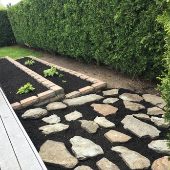 Boss D Landscape - Wall & Rock Installation with black mulch. - Landscaping Near Me - Erie, Pennsylvania Boss D Landscape - Wall & Rock Installation with black mulch. - Landscaping Near Me - Erie, Pennsylvania