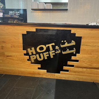 Hot & Puff - a sign on a counter in a restaurant - Burgers Near Me - Dearborn, Michigan
