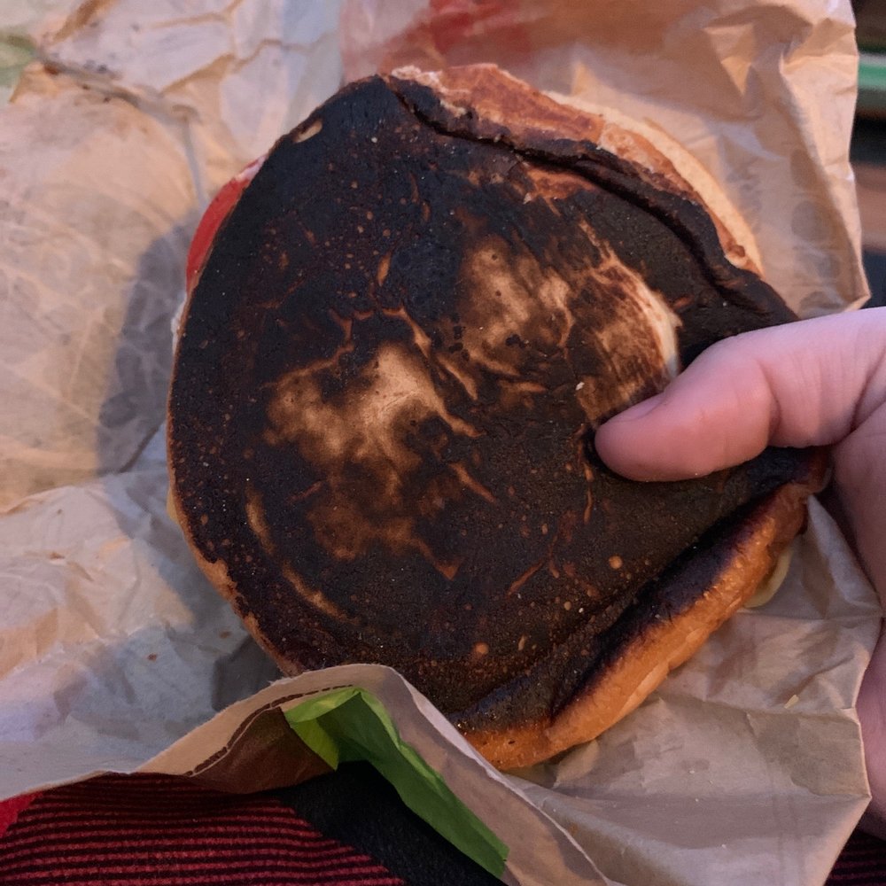 a hand holding a piece of bread a hand holding a piece of bread