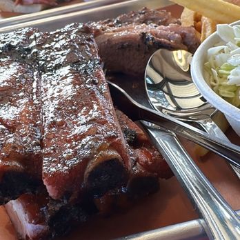 The Barbeque Pit - Short Ribs with brisket behind it. On the rear plate, a pulled pork sandwich. - Barbeque Near Me - San Jose, California The Barbeque Pit - Short Ribs with brisket behind it. On the rear plate, a pulled pork sandwich. - Barbeque Near Me - San Jose, California